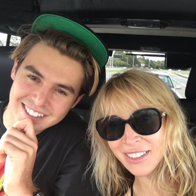 Bowen Belfort smiling in a green cap with his mother Anne Koppe.